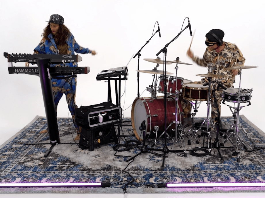Cromulon plays their instruments on a rug.